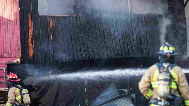 Fire-damaged home interior showing what to do after a house fire before restoration begins